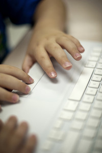 Student typing on a keyboard