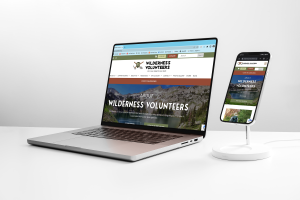 Wilderness Volunteers website shown on a laptop and cell phone